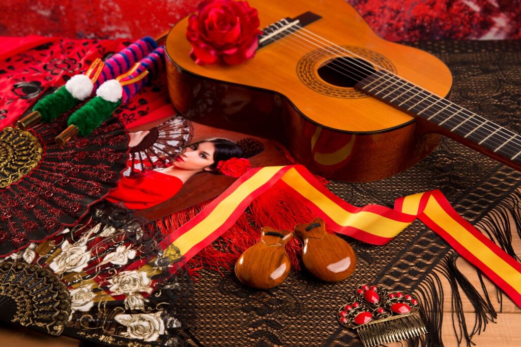 The accessories and instruments used in an authentic flamenco show in Granada include the flamenco guitar and Spanish fan