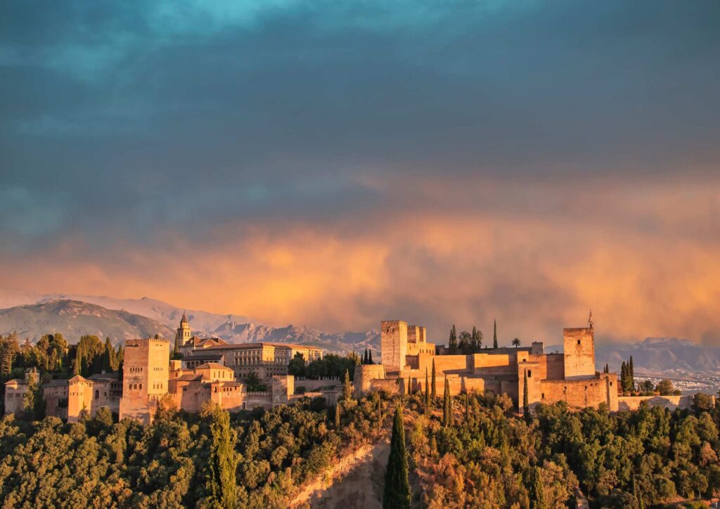 Evening view of the Alhambra Palace and Sierra Nevada mountains from the Mirador de San Cristóbal