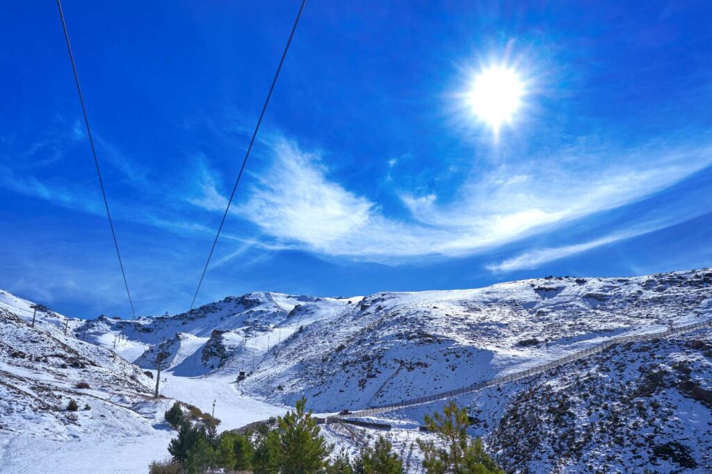 View of the ski slopes of the Sierra Nevada mountains in Granada, Spain