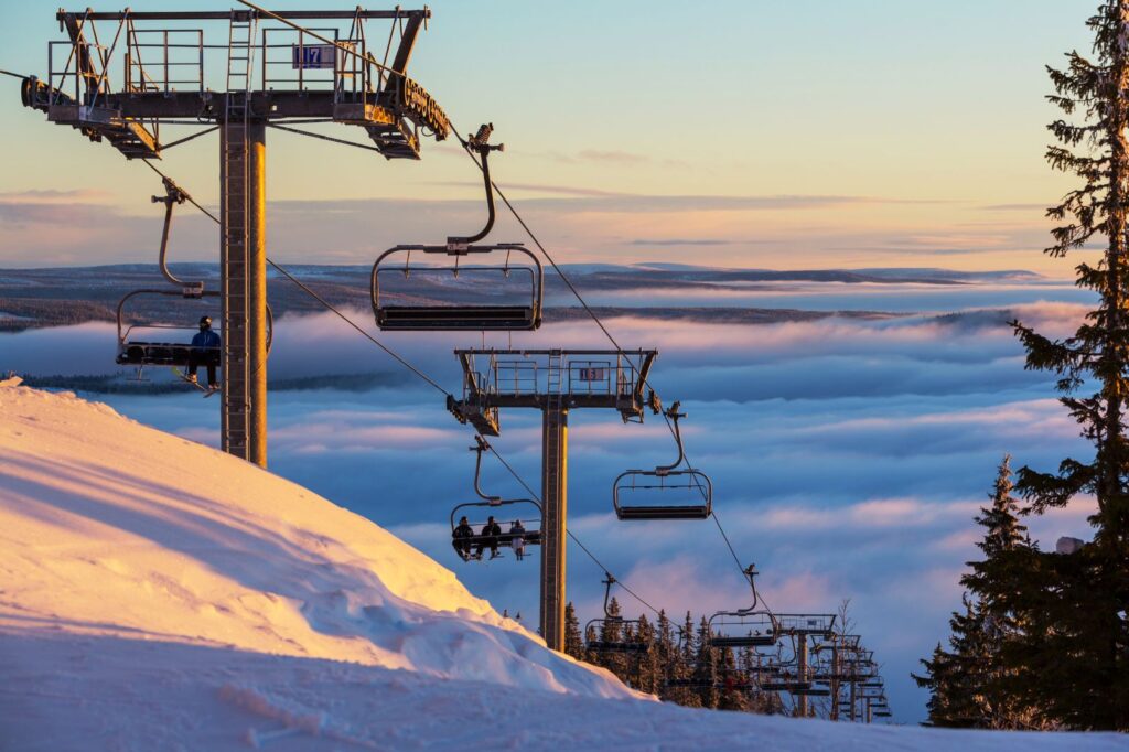 Modern ski lift carrying skiers up the Sierra Nevada mountains in Granada