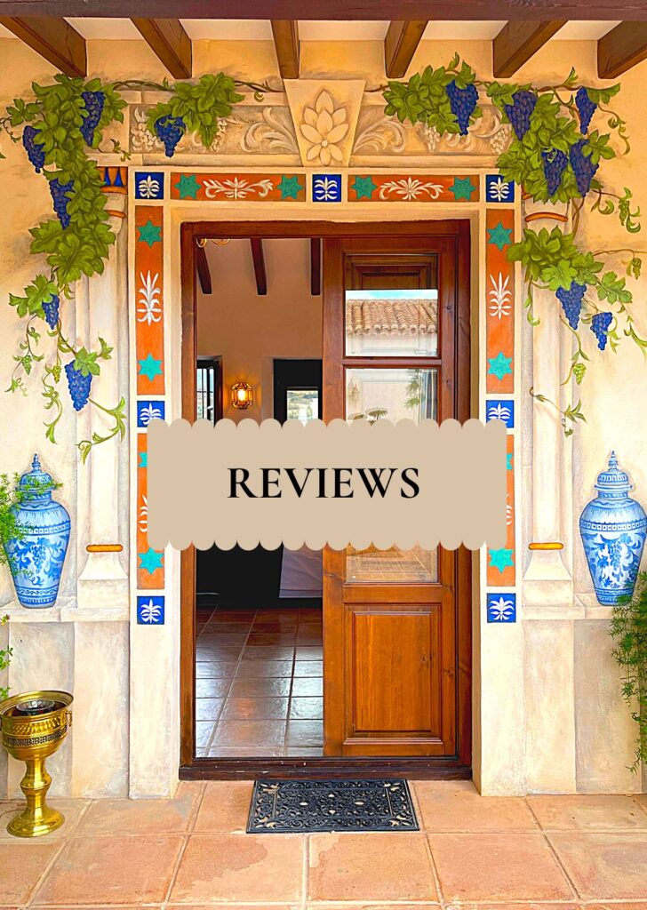 Handpainted_doorway_La_Esperanza_Granada_Spain Ornate Andalusian doorway at La Esperanza Granada private villa in Andalusia, hand-painted with colorful tiles and vine motifs, featuring blue ceramic vases and wooden beams — a reflection of authentic Spanish craftsmanship and at a luxury hacienda in Spain.