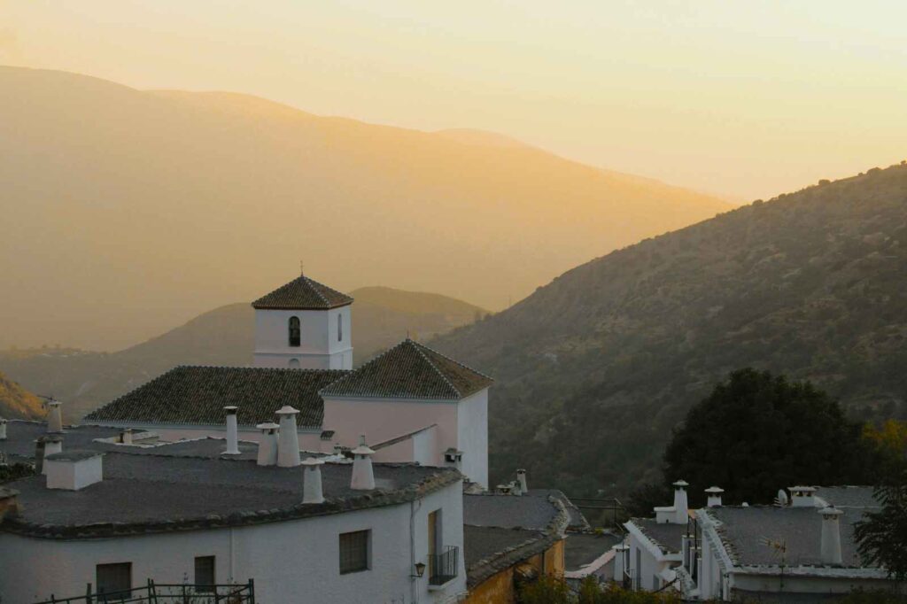 Golden sunrise over the whitewashed villages of the Alpujarras in southern Spain — a breathtaking Andalusian mountain region known for its honey, citrus, and timeless charm. This landscape inspires La Esperanza Granada’s farm-to-table philosophy and Spanish-style desserts like the best panna cotta recipe with local honey and oranges.