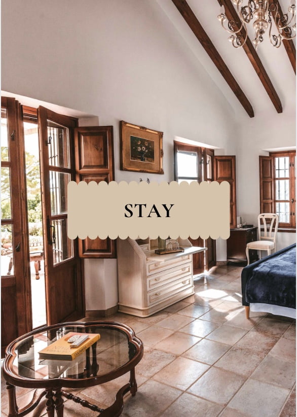 Room_with_French_Doors_Spanish_Hacienda Luxury suite at the La Esperanza Granada private villa in Andalusia, with vaulted wooden-beam ceiling, Andalusian-style windows, chandelier, and sunlit terrace doors — an elegant hacienda stay in Granada, Spain.