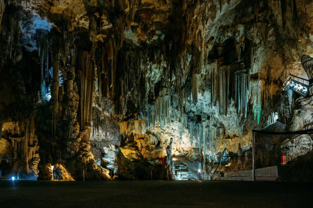 Majestic interior of the Caves of Nerja in Andalusia, Spain, showing vast limestone formations, towering stalactites, and illuminated rock columns inside one of Europe’s largest underground caverns on the Costa Tropical.