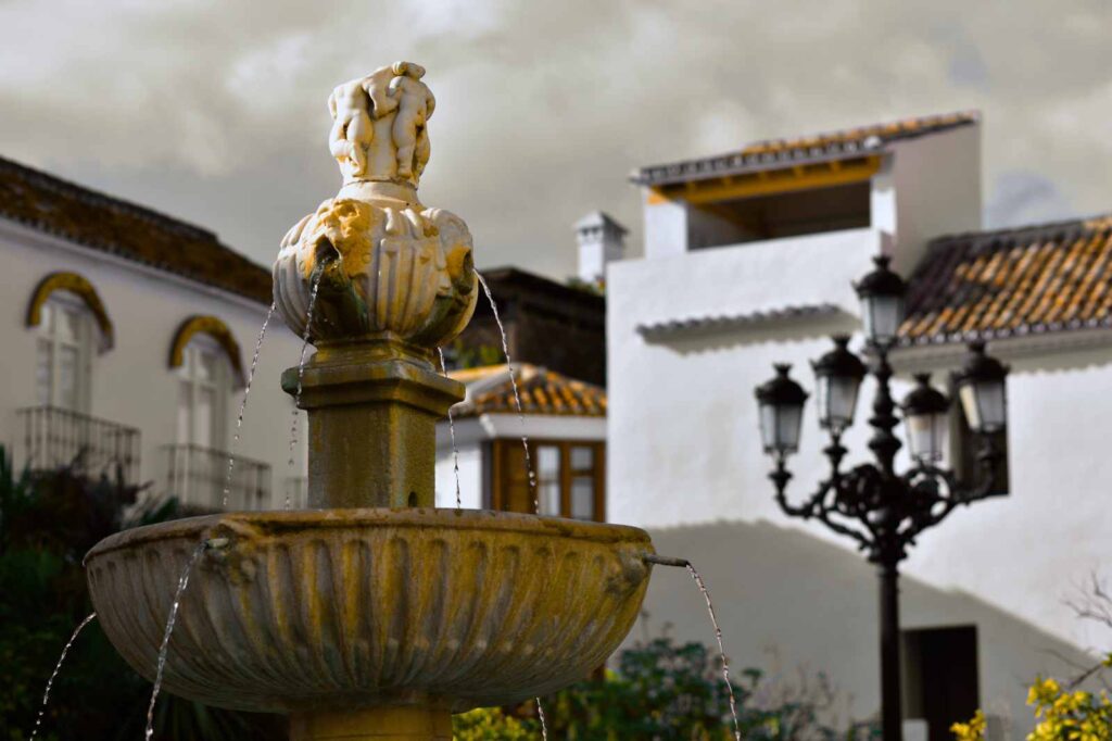 Stone fountain in Marbella’s Old Town surrounded by traditional Andalusian white houses, tiled roofs, and wrought-iron balconies — a peaceful scene in one of southern Spain’s most charming plazas.